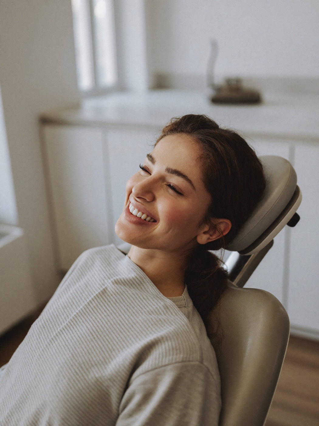 Paciente sonriendo en un sillón dental